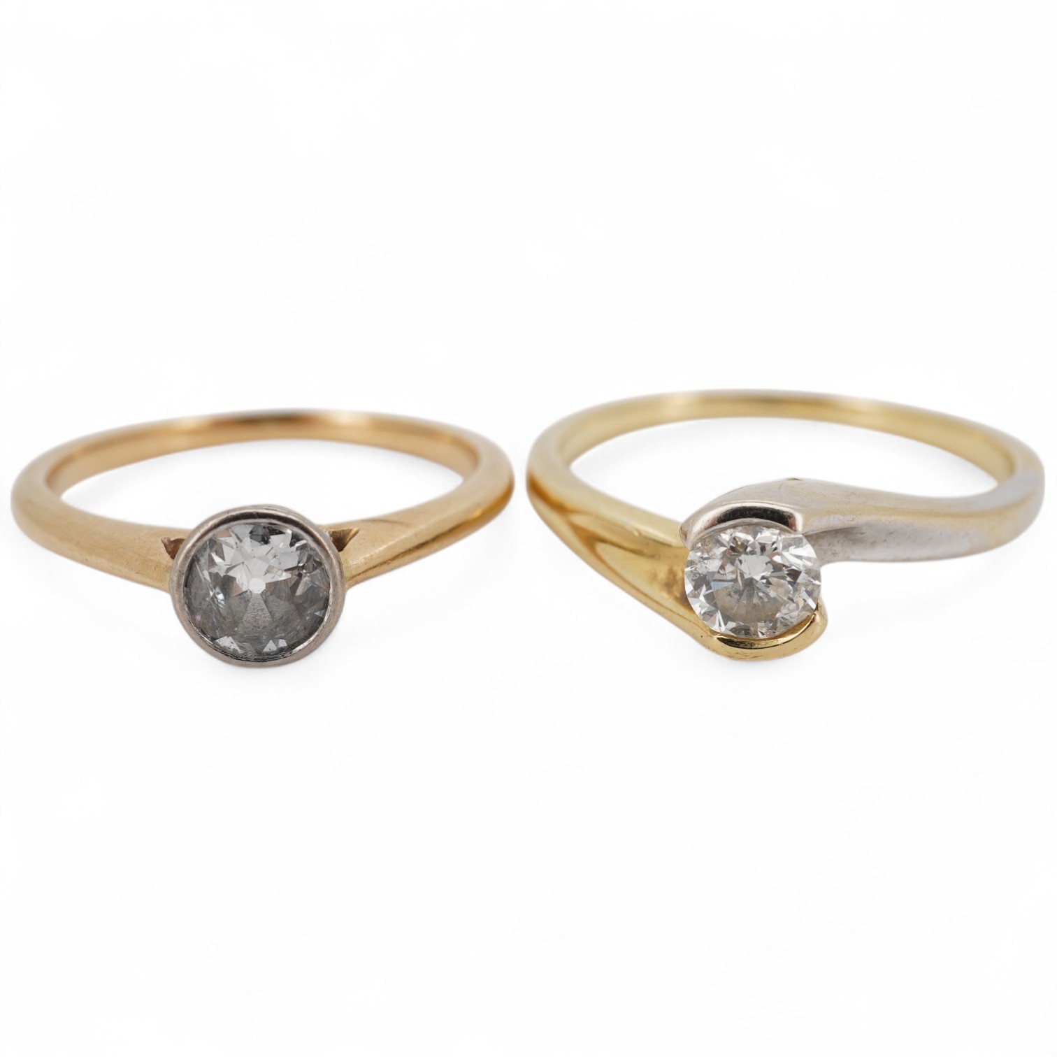 A modern two colour 18ct gold and solitaire diamond set ring, size N/O, the stone weight 0.33ct, together with a yellow metal and collet set solitaire diamond ring, size K, the stone weighing approximately 0.45ct, gross
